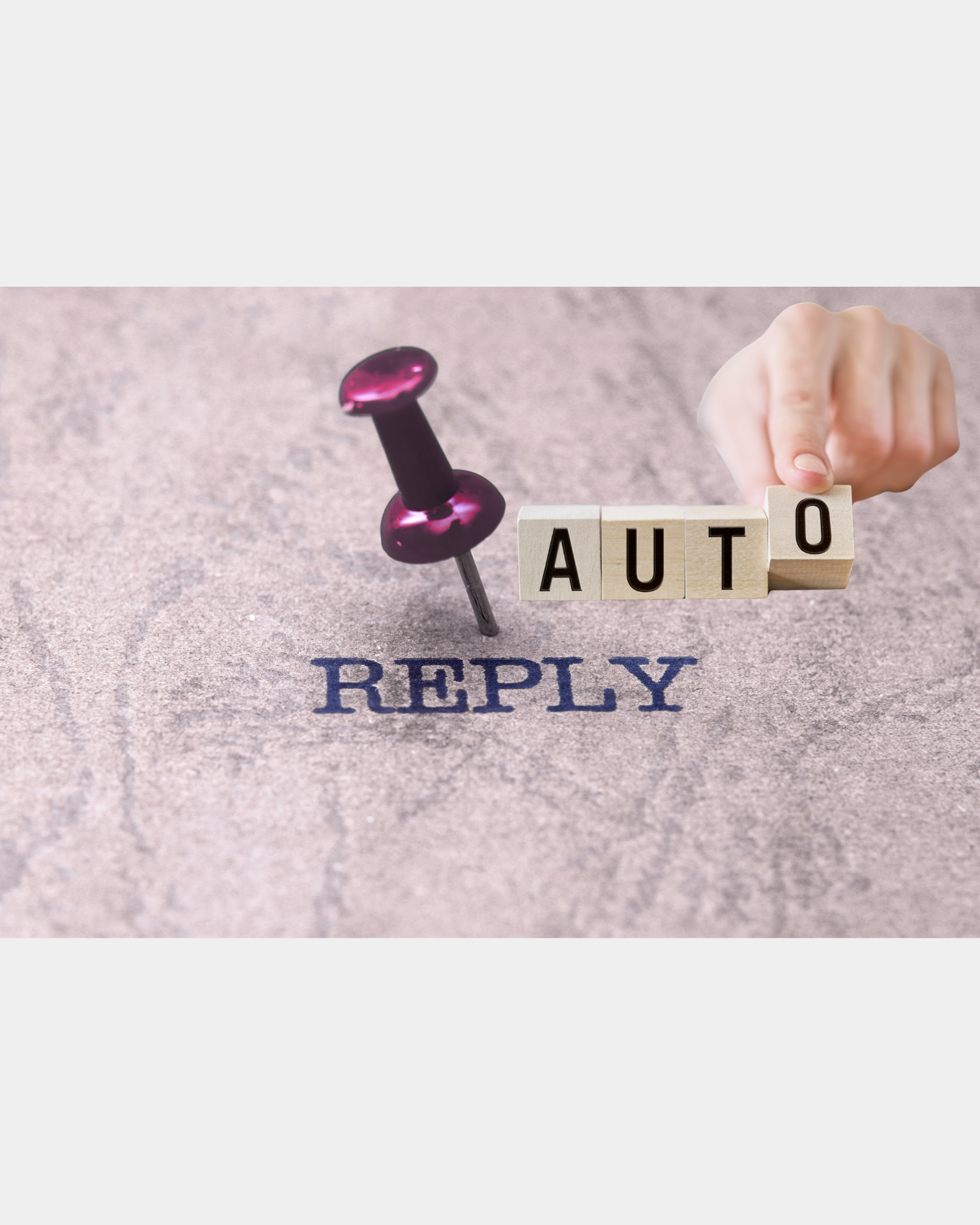 Auto reply spelled with wooden blocks beside a push pin