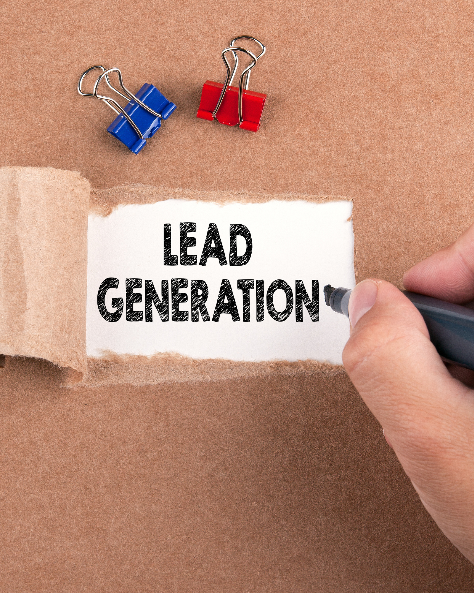 Lead generation written on a note with office clips