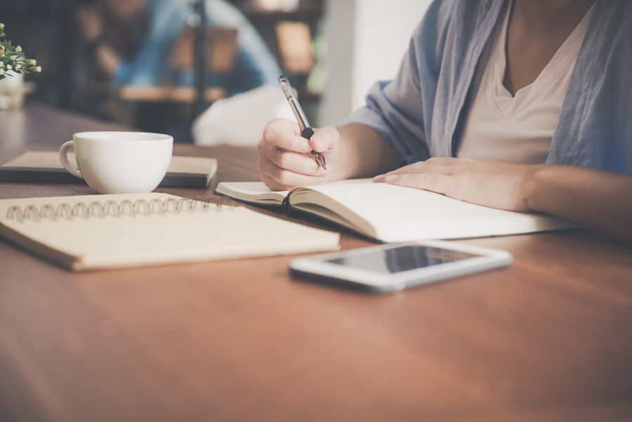 Blogger writing an article at a laptop