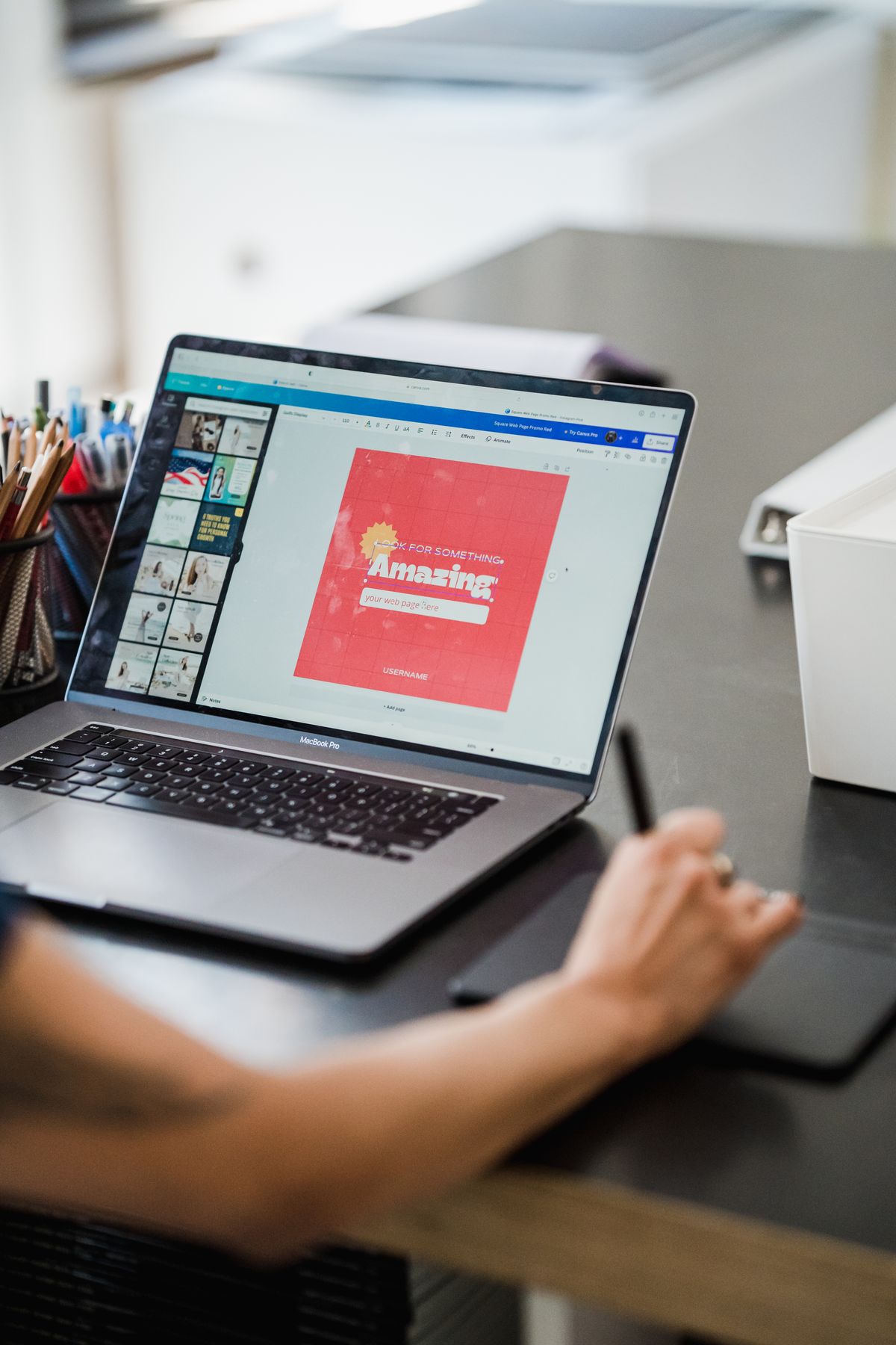Creator designing a digital product with a laptop and drawing tablet