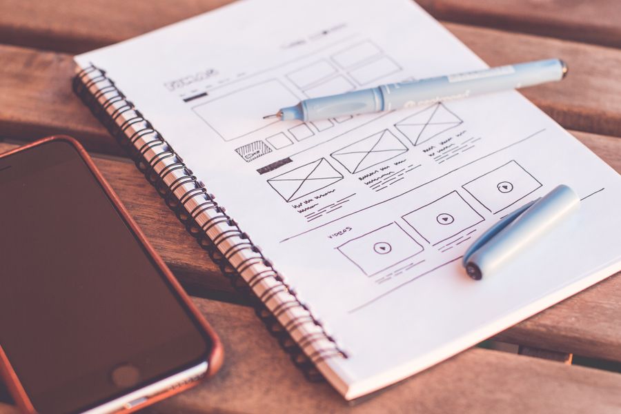 Designer working with creative tools at a desk