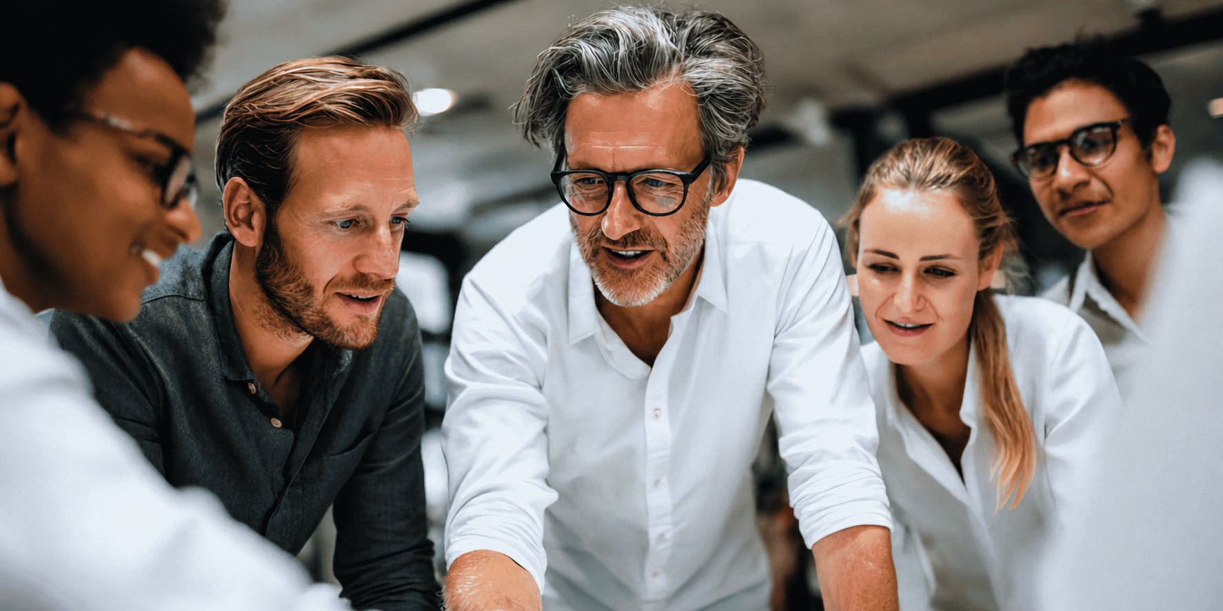Agency owners and colleagues collaborating closely around a shared project