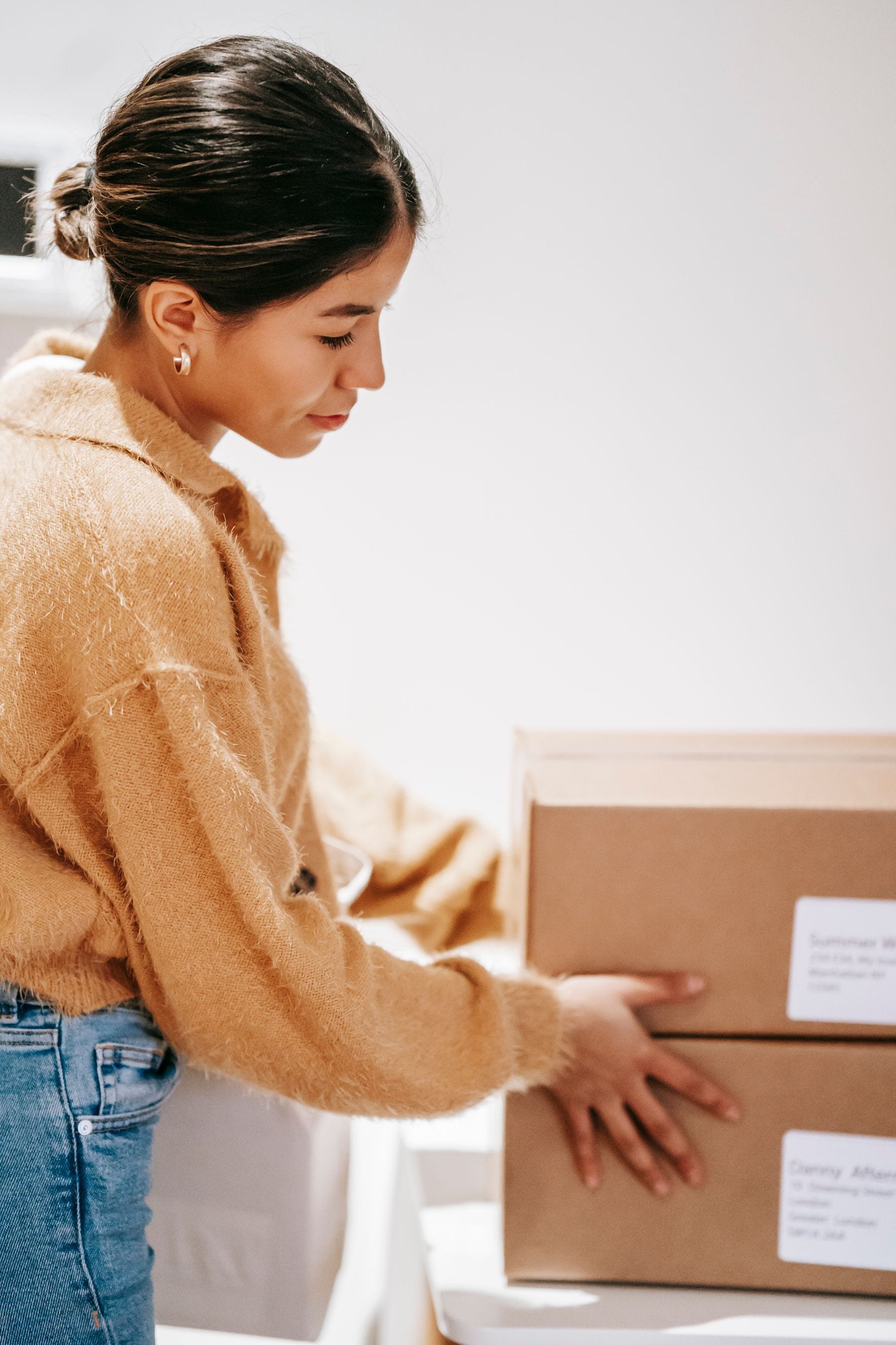 Online shopper organizing delivered ecommerce packages
