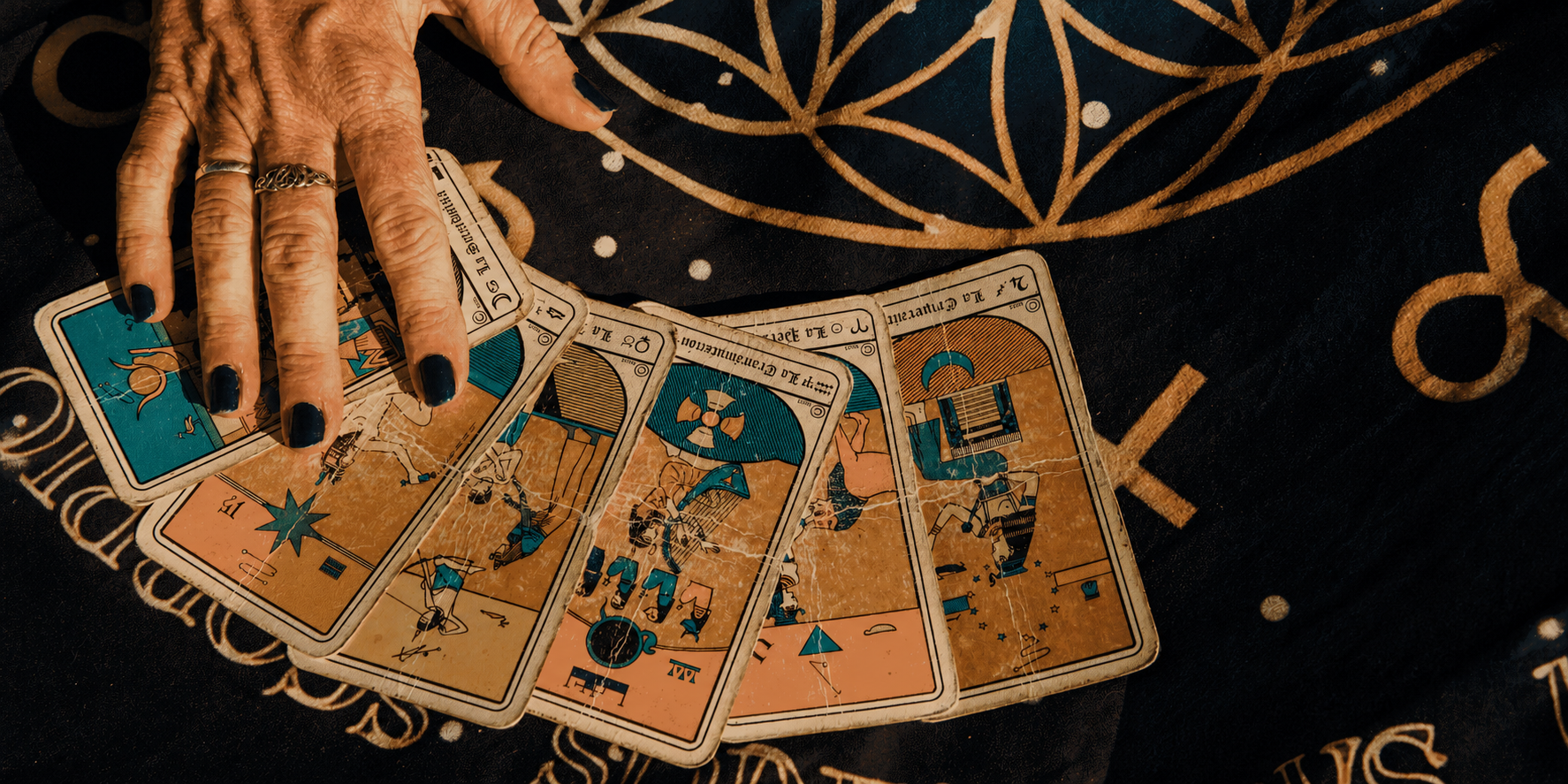 Astrology creator arranging illustrated divination cards on a celestial cloth