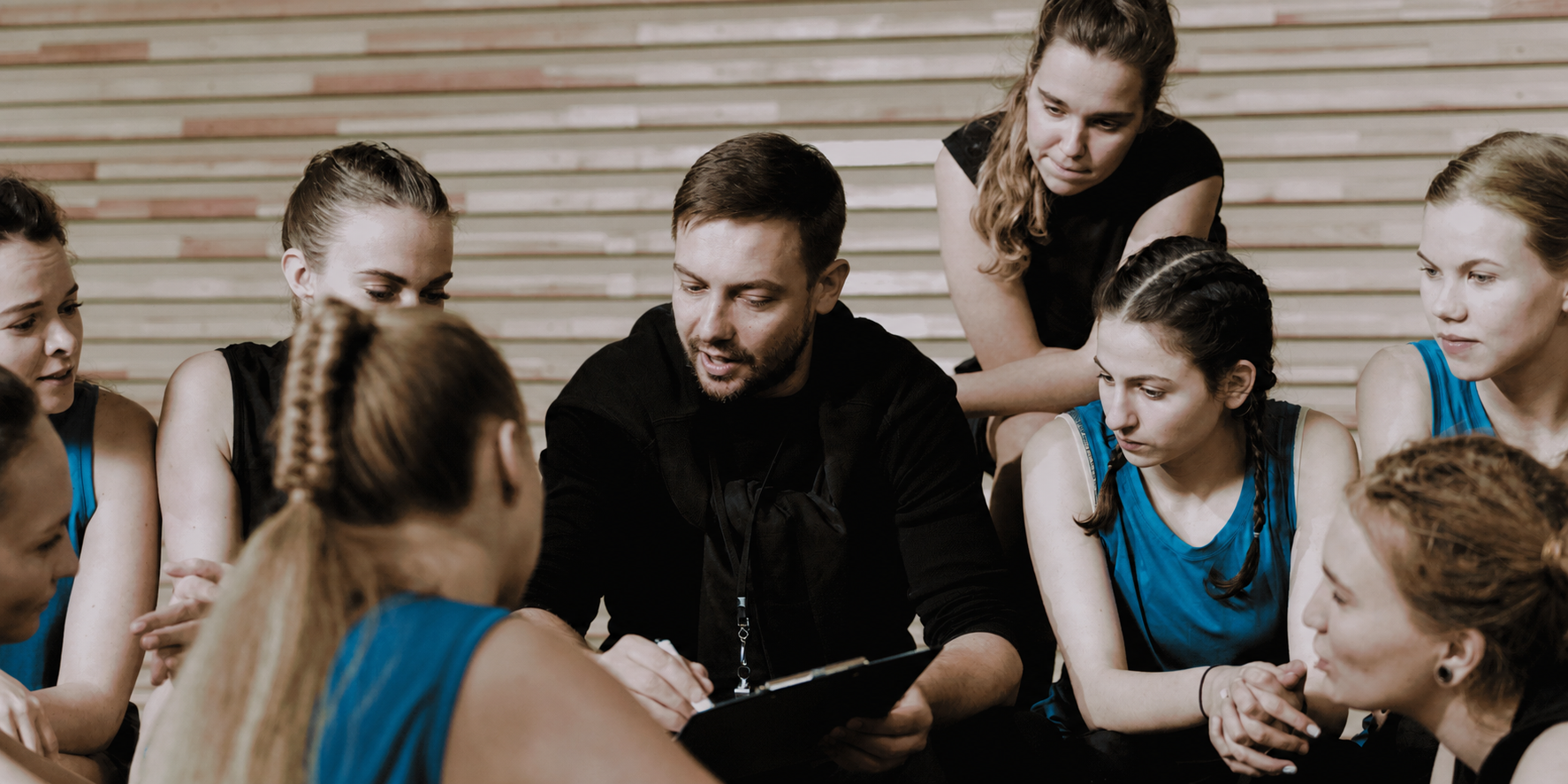 Coach guiding a focused group through a team training session