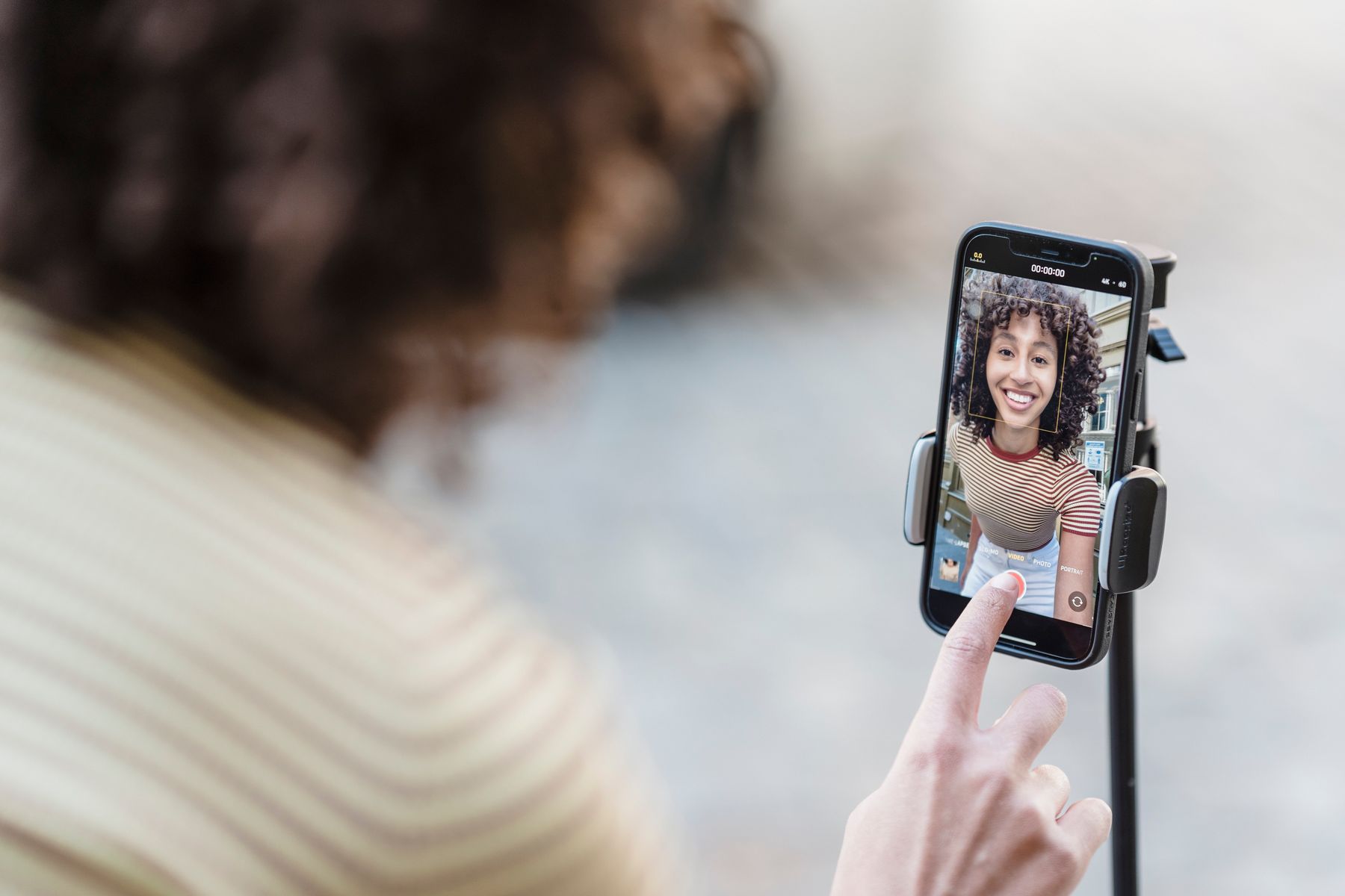 Content creator recording a social media video on a smartphone