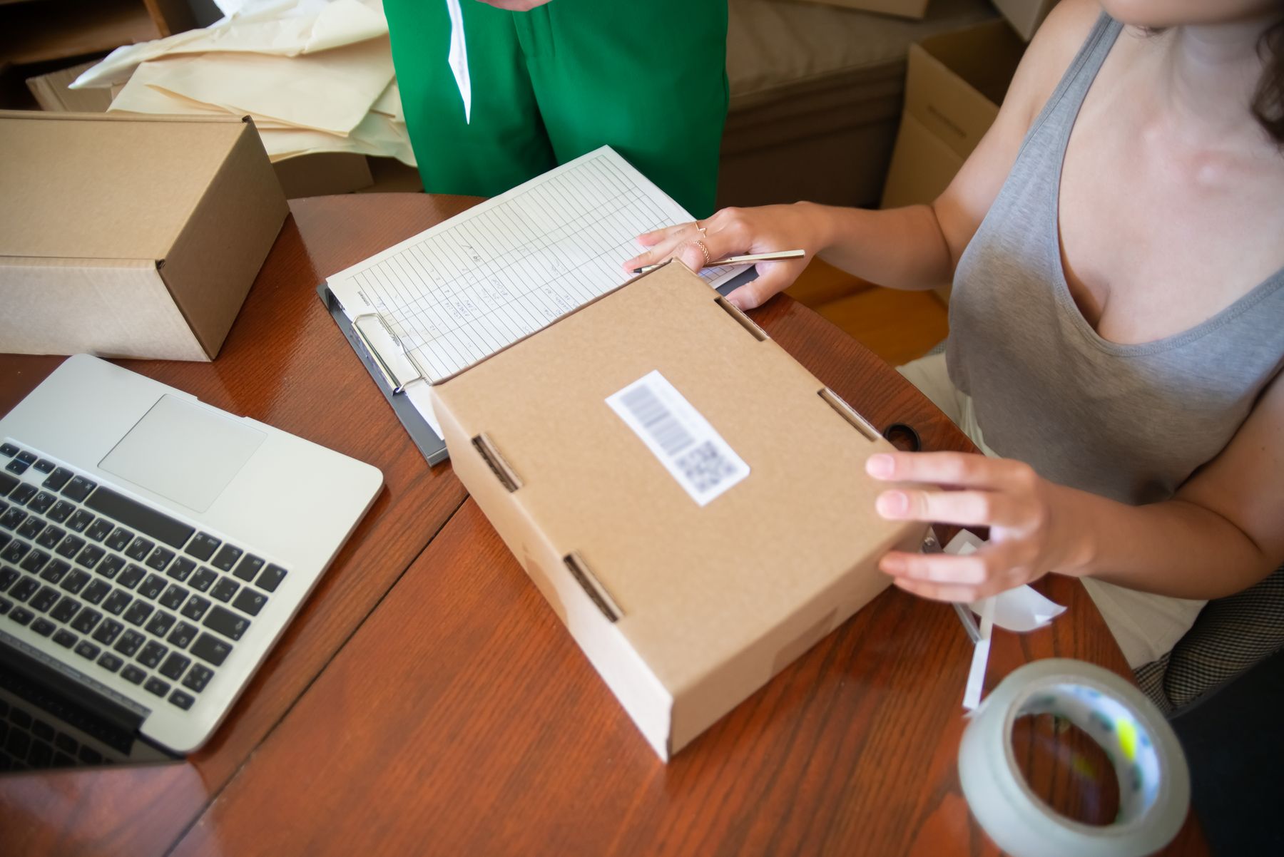 Small business owner packing customer orders at a worktable