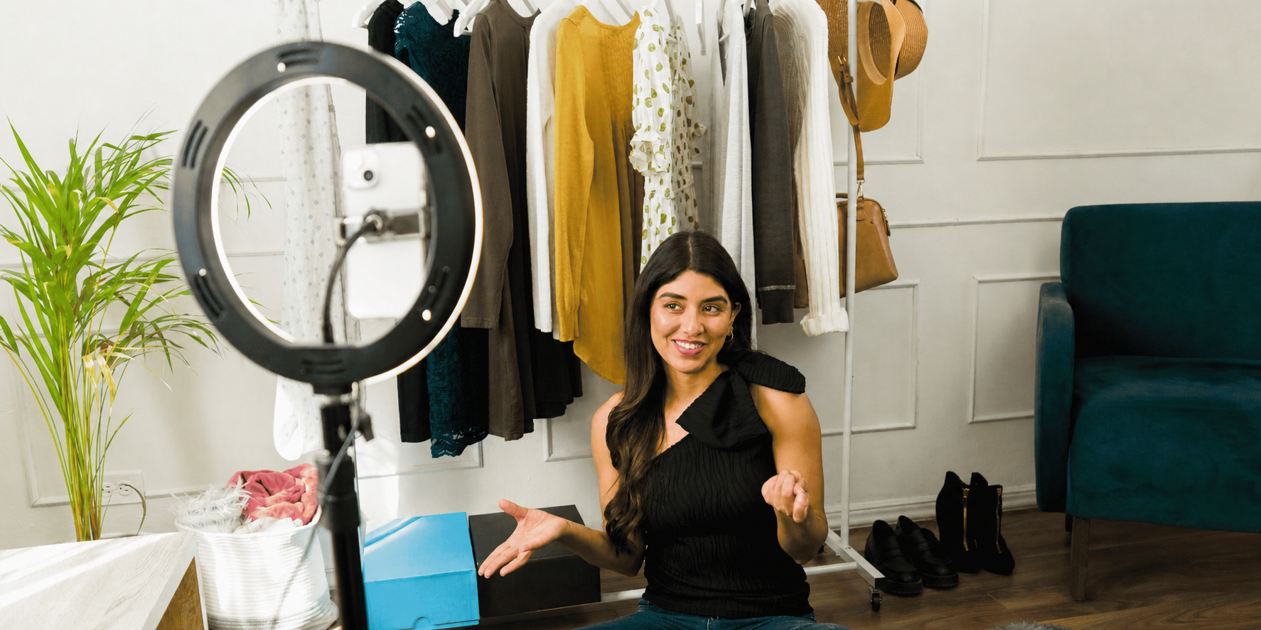 Fashion influencer recording outfit content with a smartphone and ring light