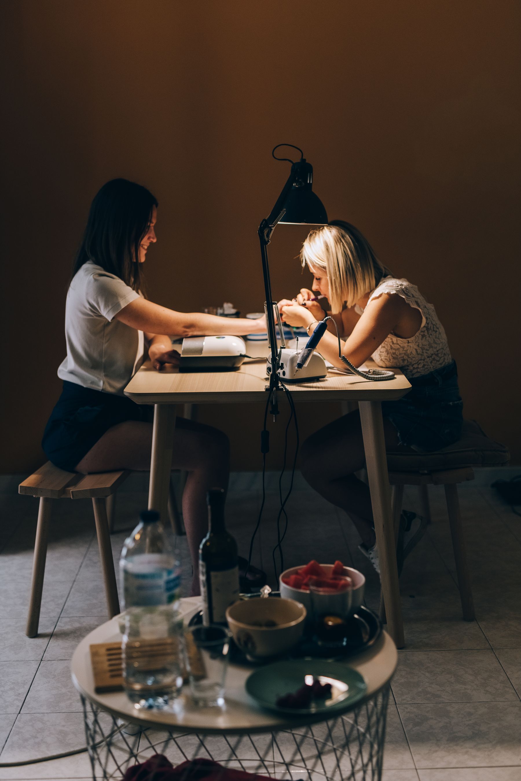 Nail technician providing a manicure for a client