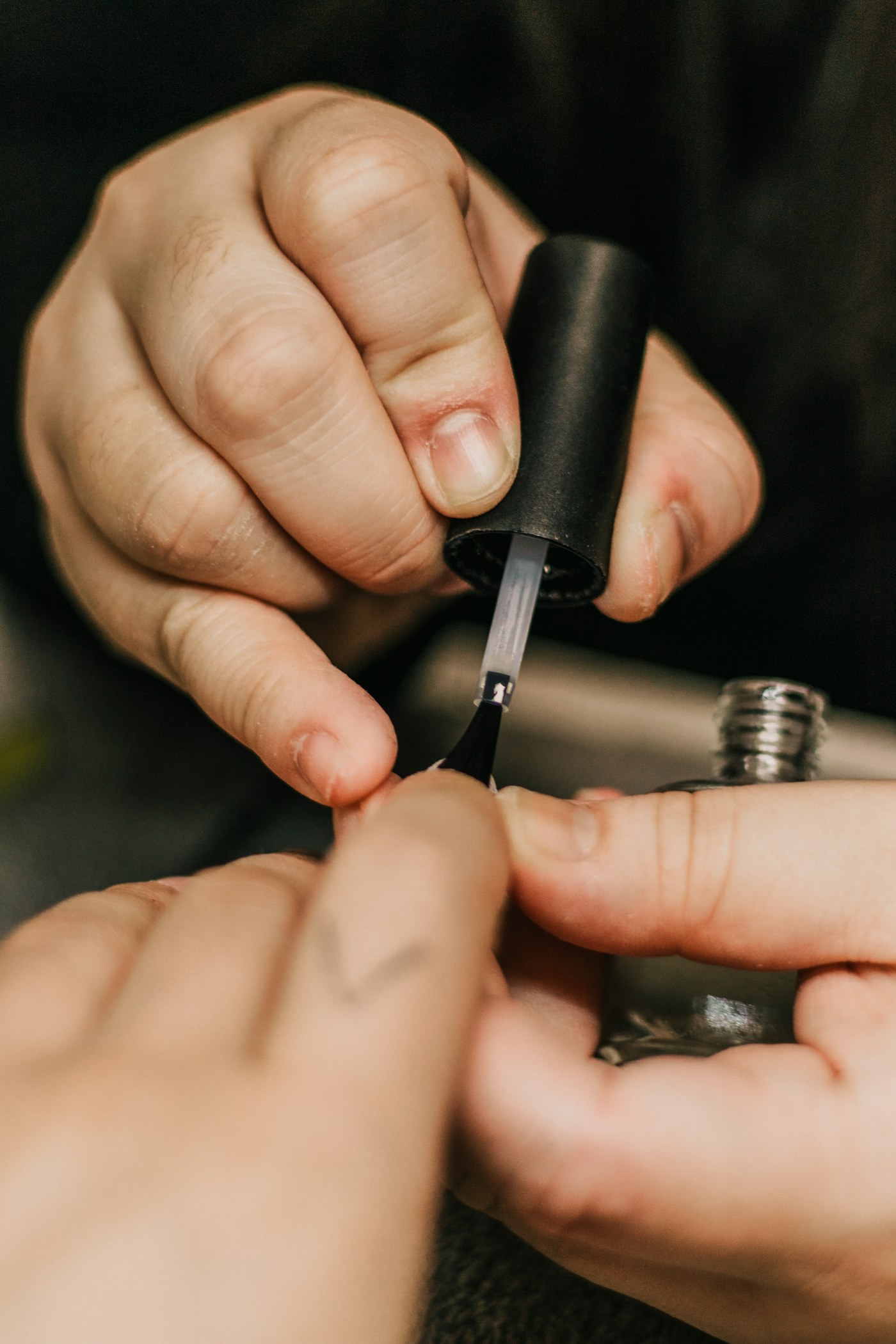 Person holding black and silver hand tool
