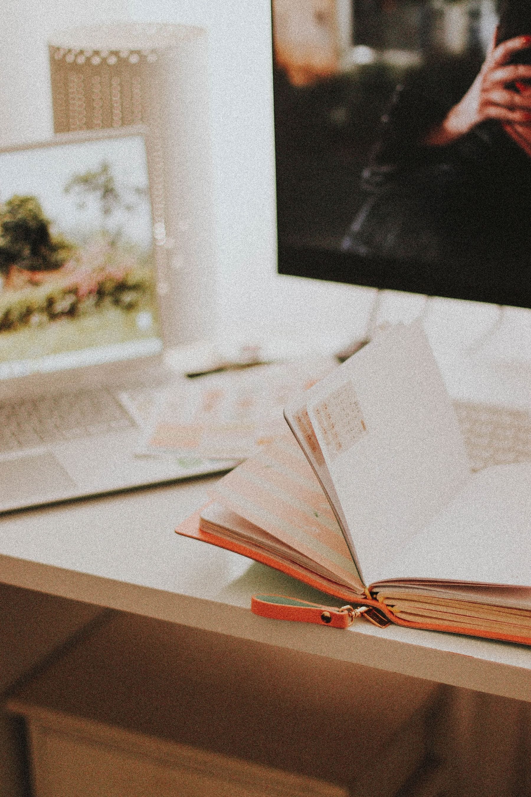 Digital planning workspace with an open planner and laptop