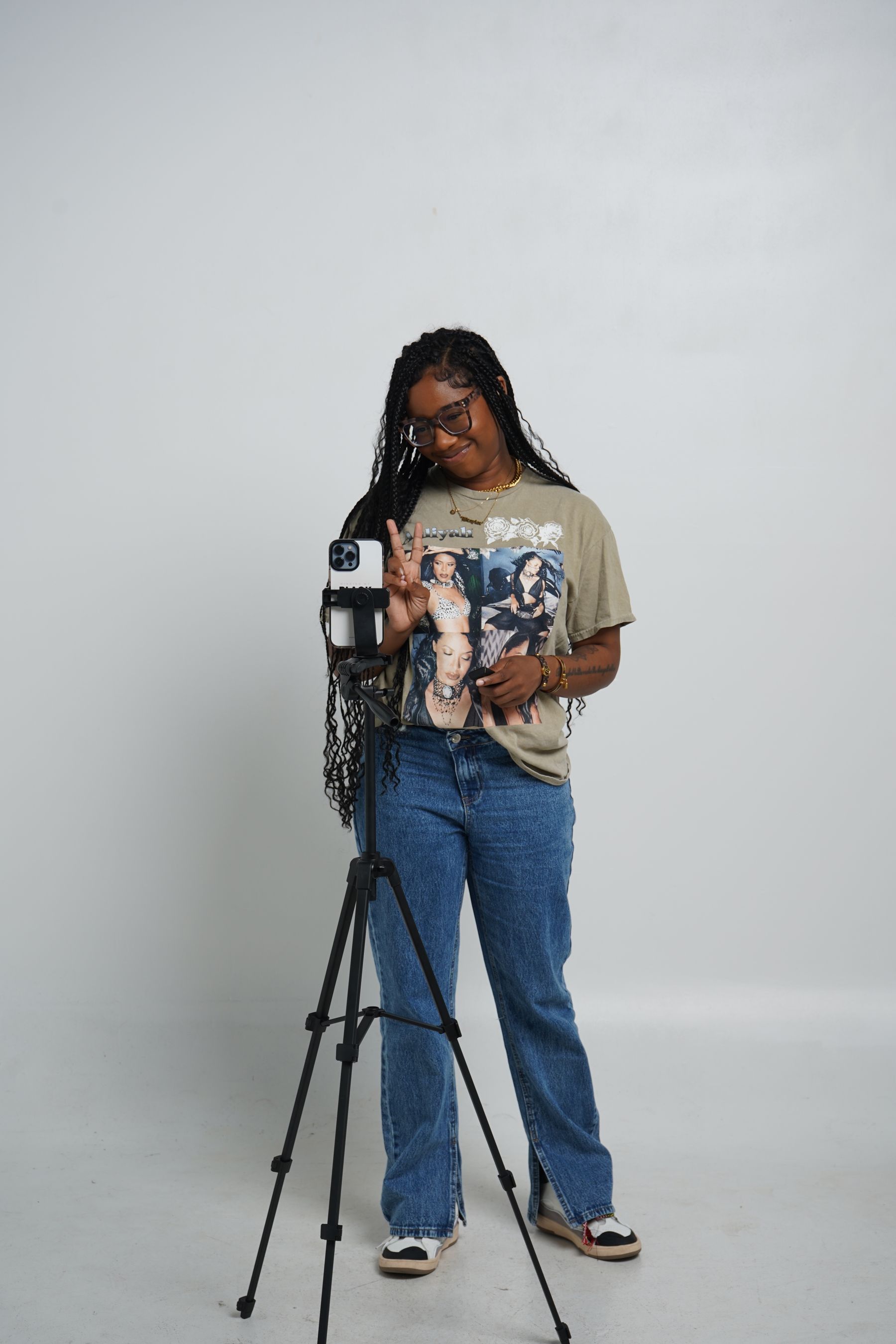Independent content creator posing beside a home camera setup