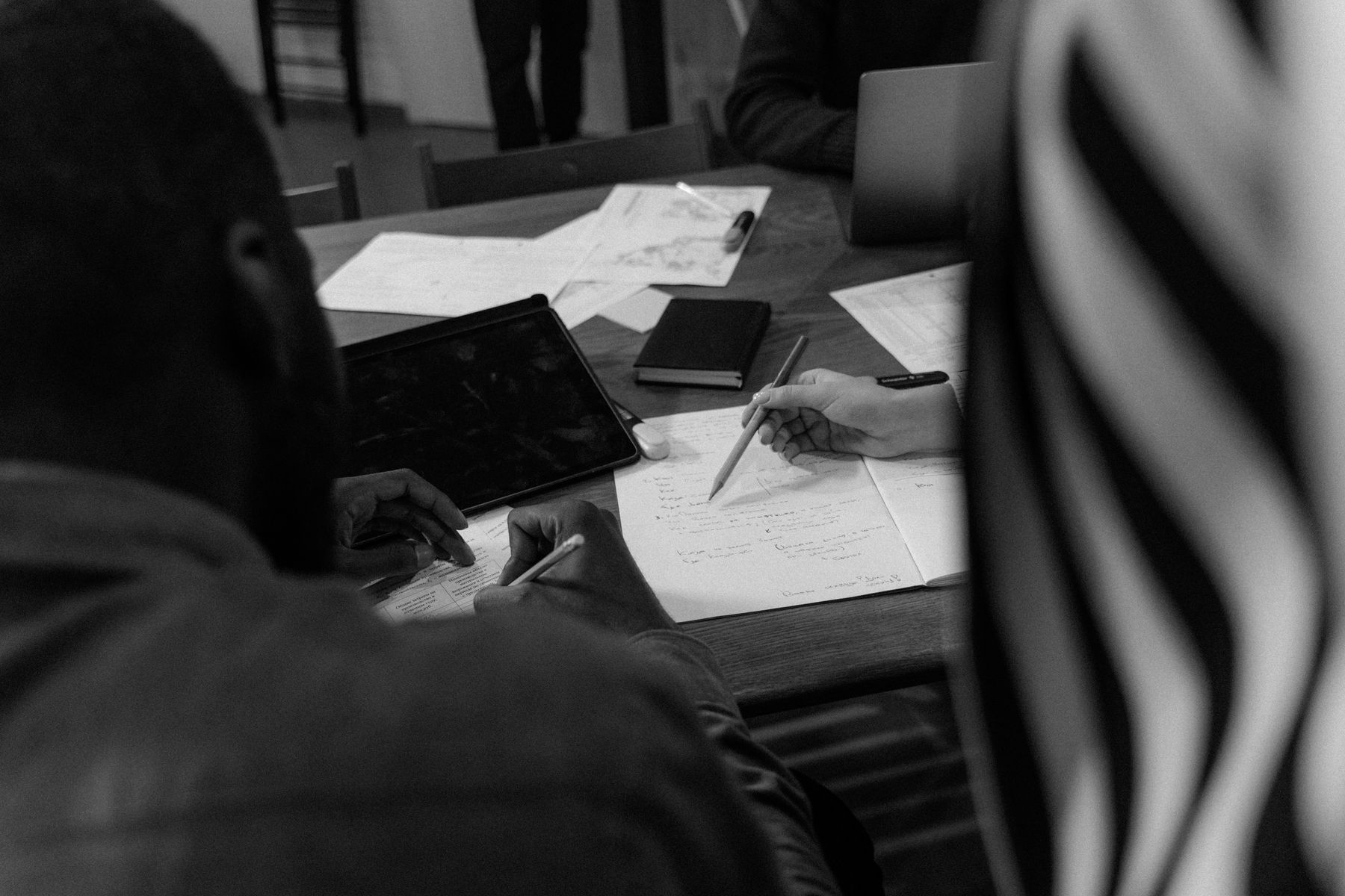 Software team reviewing product documentation during a meeting