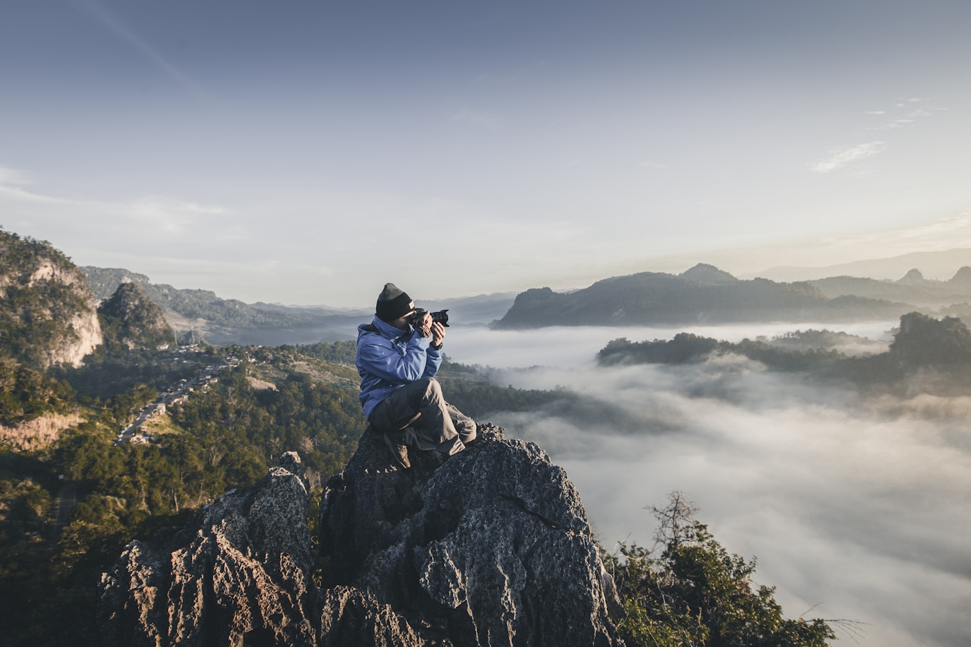 Man on top of mountain taking pictures