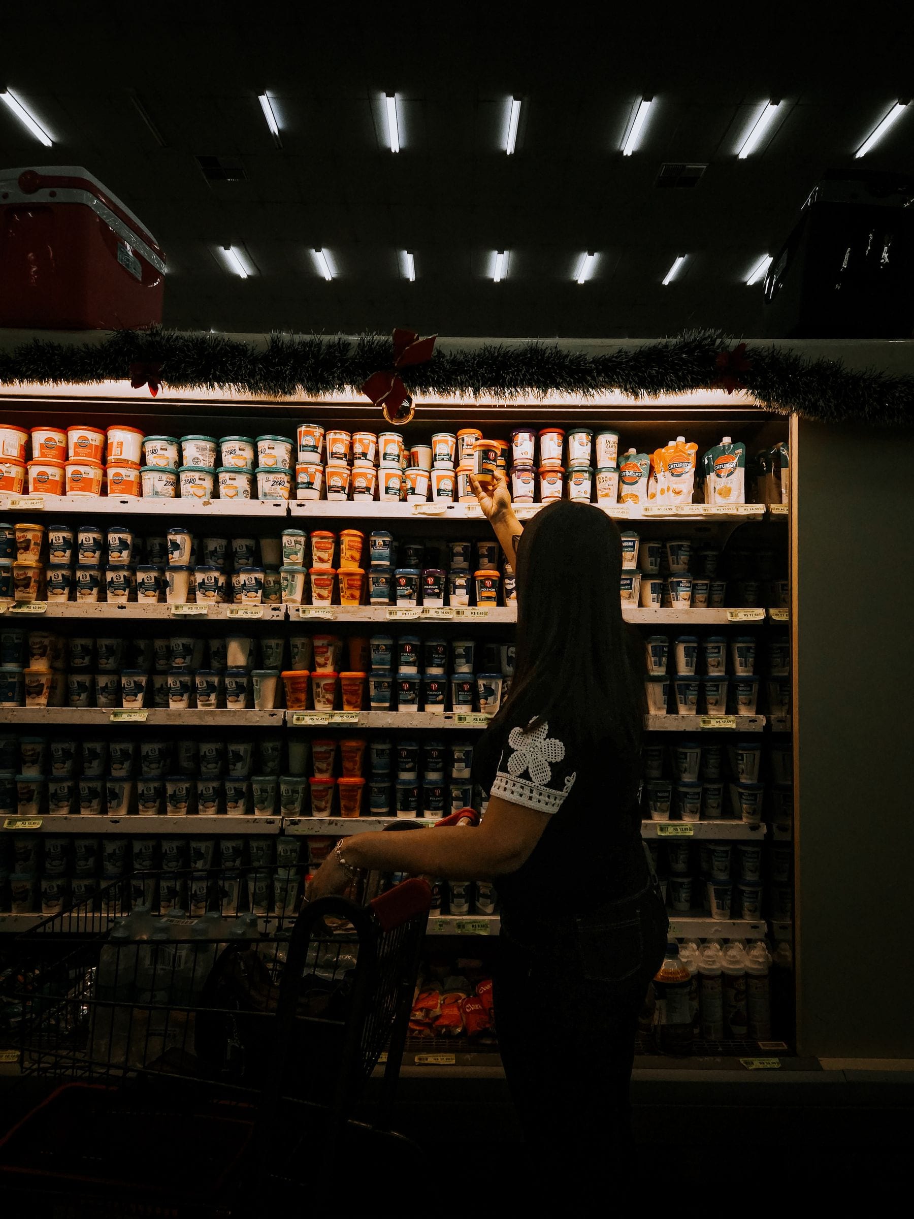 Shopper finding products in a grocery store aisle