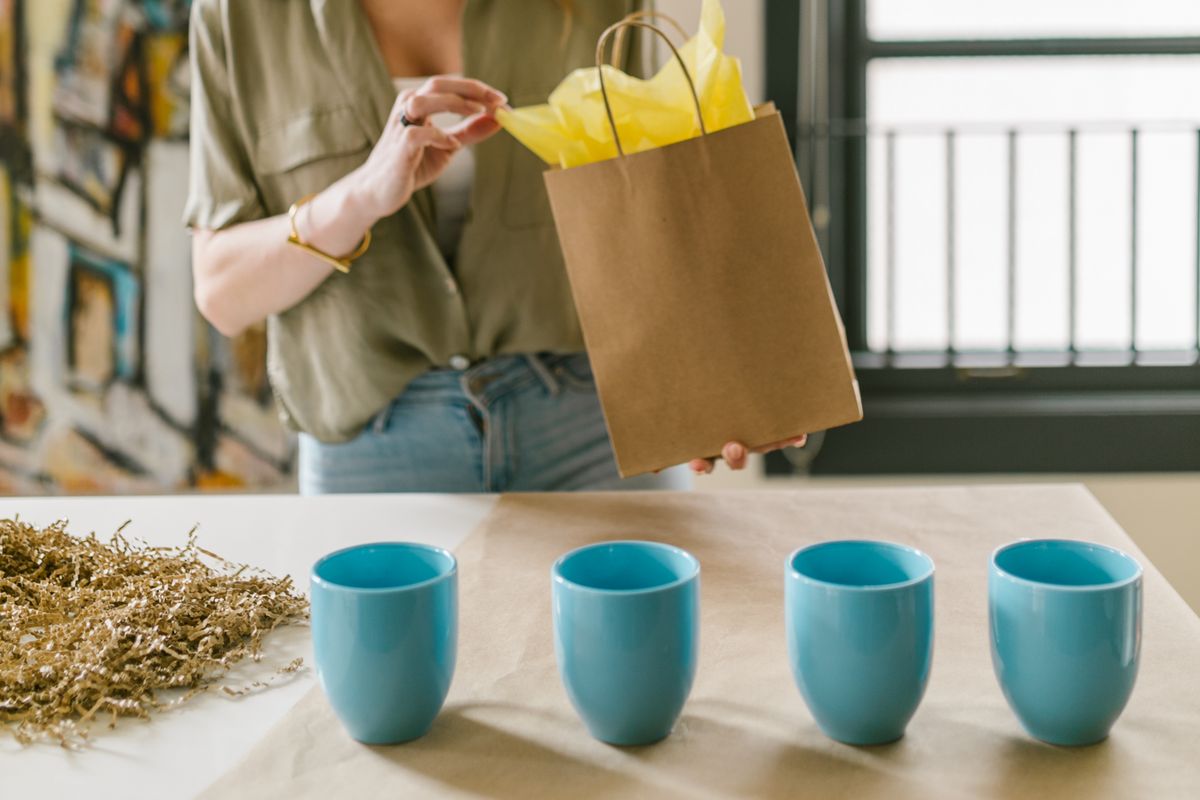 Handmade shop owner packing products for a customer