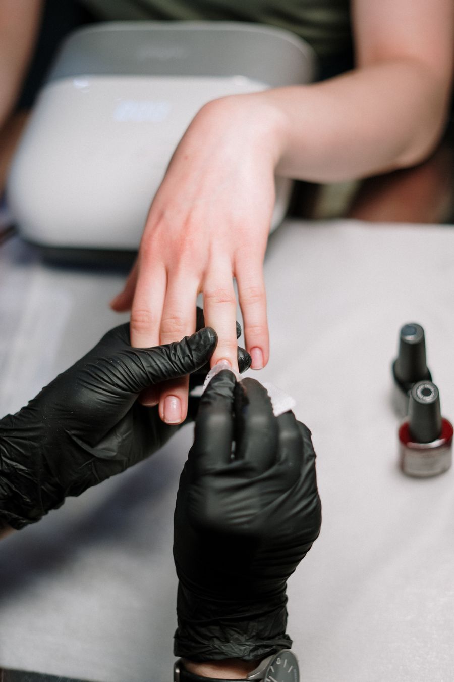 Nail technician creating a manicure design