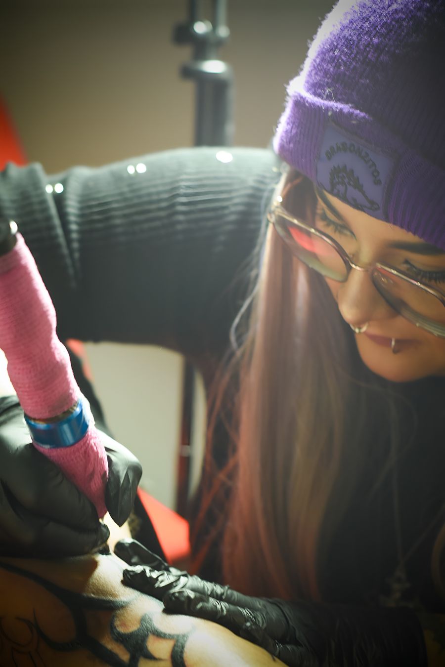 Tattoo artist creating a design in a studio