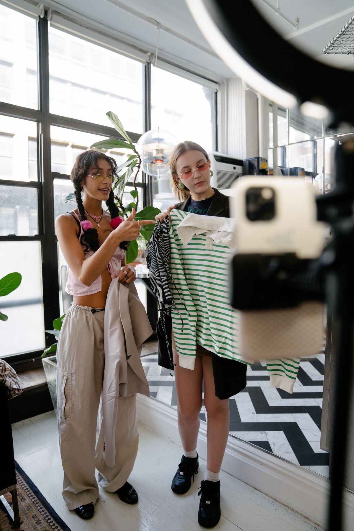 Two fashion influencers filming an outfit video for social media